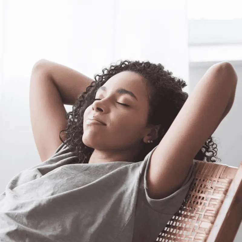 Relaxed woman resting on chair after booking a flat rate home cleaning – Easy Bliss Brisbane
